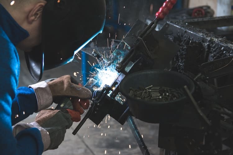 welder wearing a welding helmet