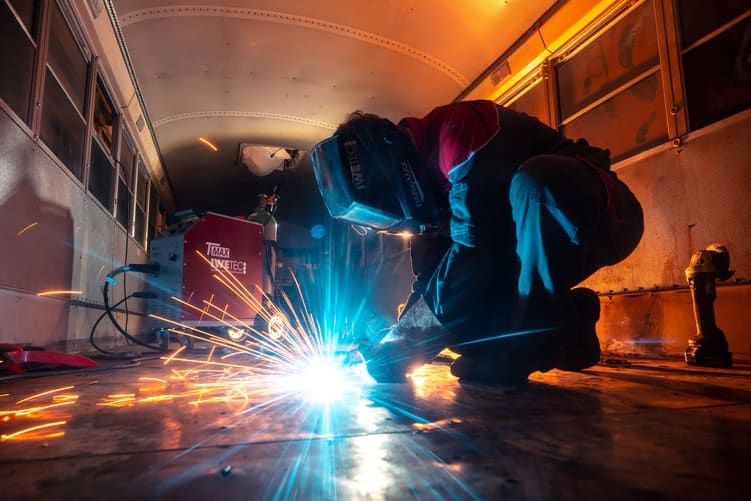 welder wearing a welding helmet